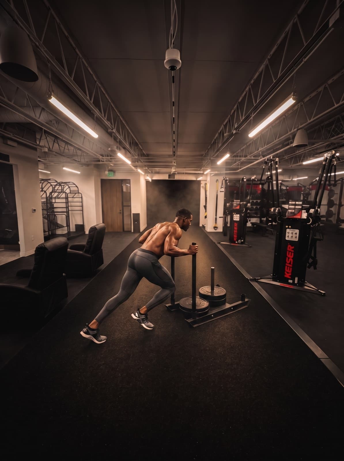 Athlete performing a sled push on the training floor